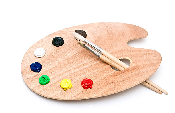 istock wooden art palette with paint and brushes isolated on white 467317587