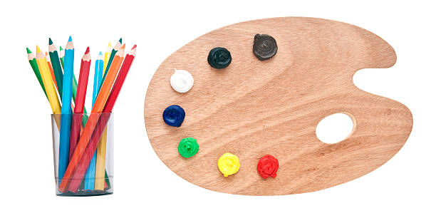 istock wooden artists palette loaded with various colour paints 467319191