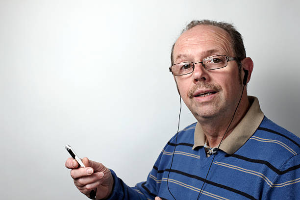 istock Mature man singing along to MP3 player music 467319433