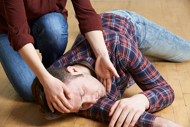 A man being placed in recovery position after accident stock photo