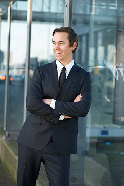istock Happy businessman smiling outdoors with arms crossed 467320205