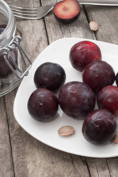 istock plums on a wooden background 467322439