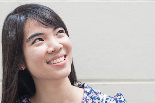 istock cheerful woman thinking and looking up with high aspirations 467325321