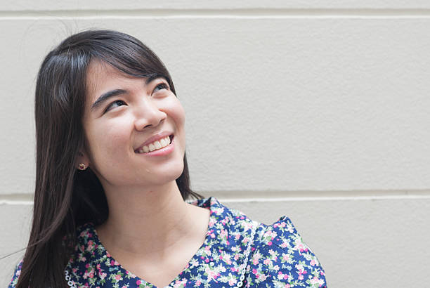 istock cheerful woman thinking and looking up with high aspirations 467325335