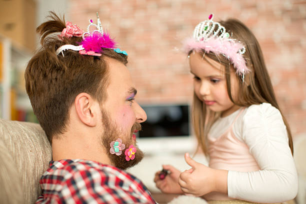 istock Cute daughter making up her father. 467325498