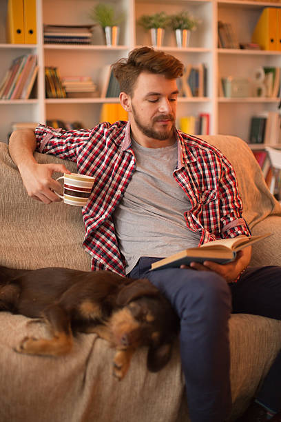 istock Young man at home with his dog. 467325620