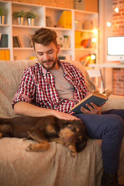 istock Young man at home with his dog. 467325622
