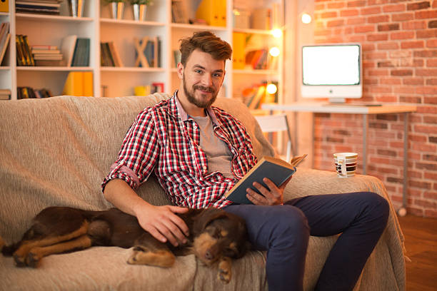 istock Young man at home with his dog. 467325626