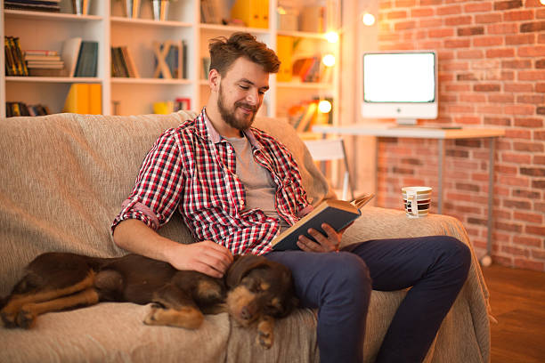 istock Young man at home with his dog. 467325628