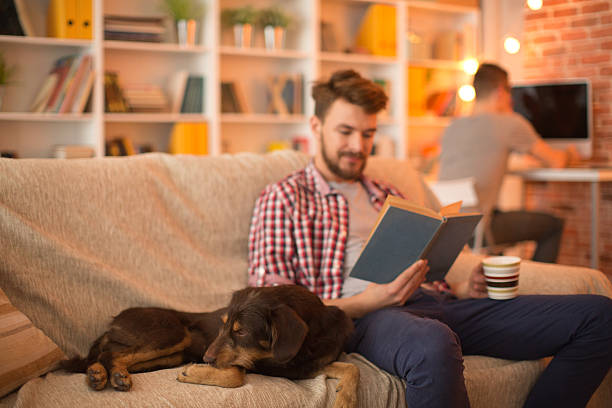 istock Young man at home with his dog. 467325630