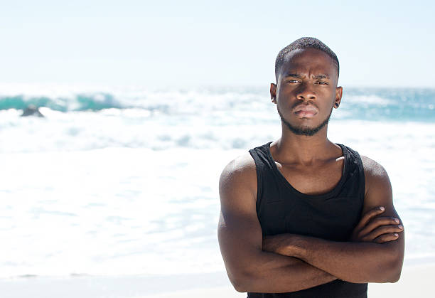 istock Attractive young man standing at the beach 467328326