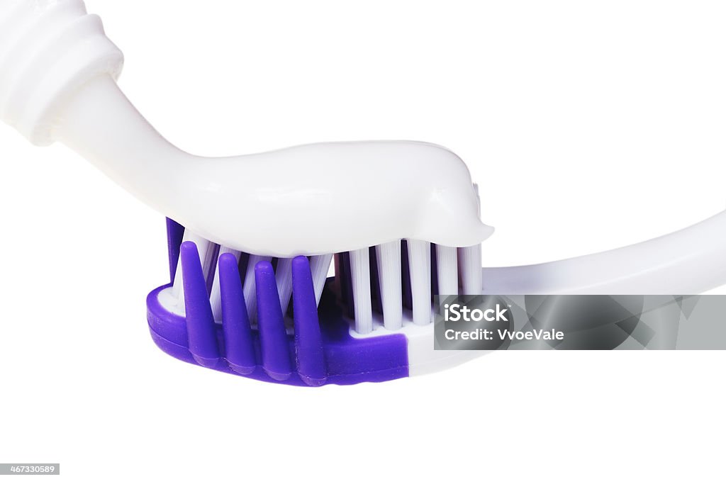 toothbrush and toothpaste from tube squeezed tooth paste from tube on modern toothbrush close up isolated on white background Cleaning Stock Photo