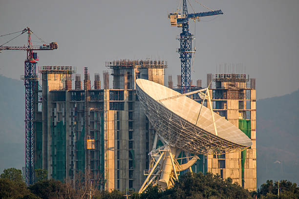 istock Large satellite dish on the building onstruction background 467330870