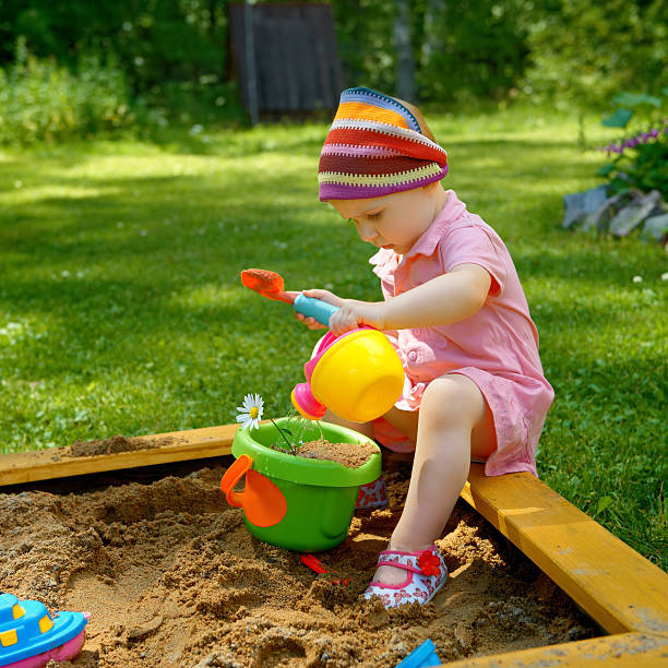 Baby girl playing in the sandbox