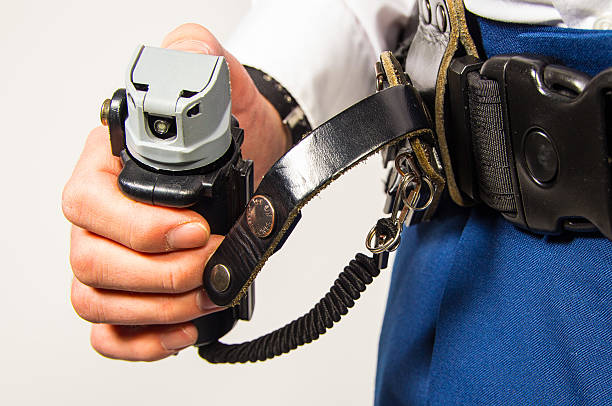 A close behind view of Japanese police belt with extendable baton night stick and handcuffs.