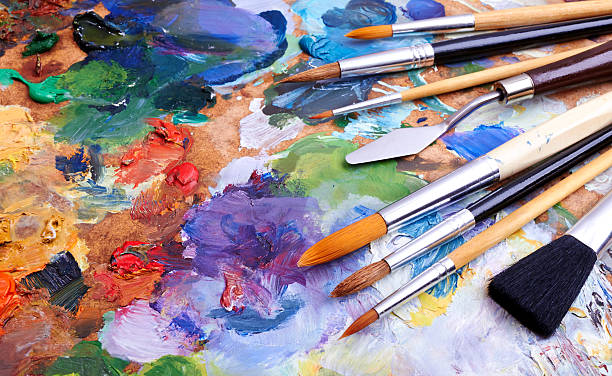 Colorful artist brushes and paint artists brushes and oilpaints on wooden palette oil paint palette stock pictures, royalty-free photos & images