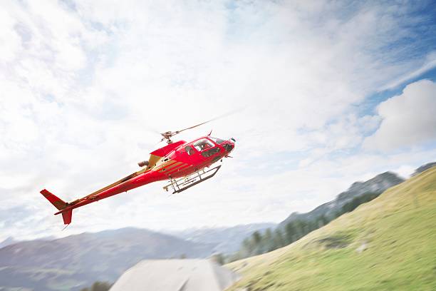 istock Red Helicopter Landing on Mountainside 467333215