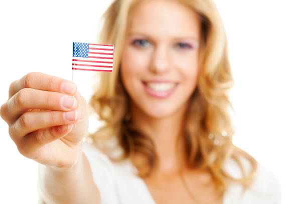 istock Young blond woman holding American flag 467333975