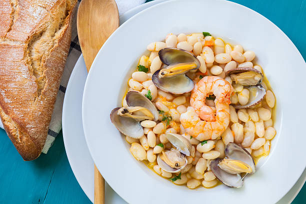 Beans and clams fabes con almejas is a homemade beans and clams seafood from spain culture fabes stock pictures, royalty-free photos & images