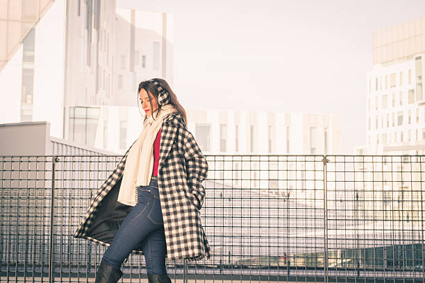 istock Beautiful young brunette posing in the city streets 467334970