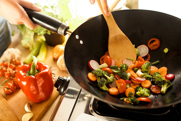 istock Chef cooking vegetables in wok pan 467335136