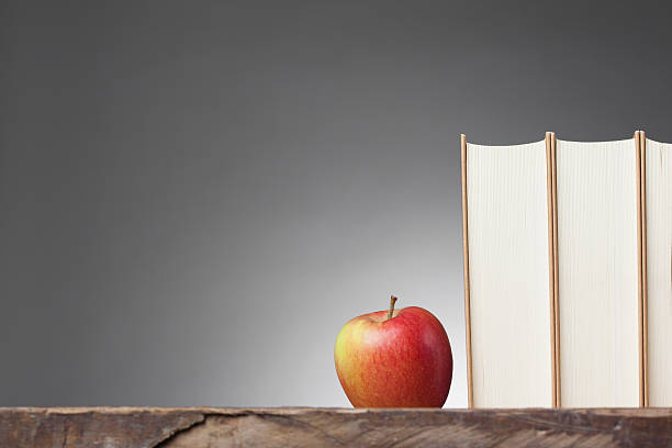 istock Books on a wooden Table, with an Apple 467336569