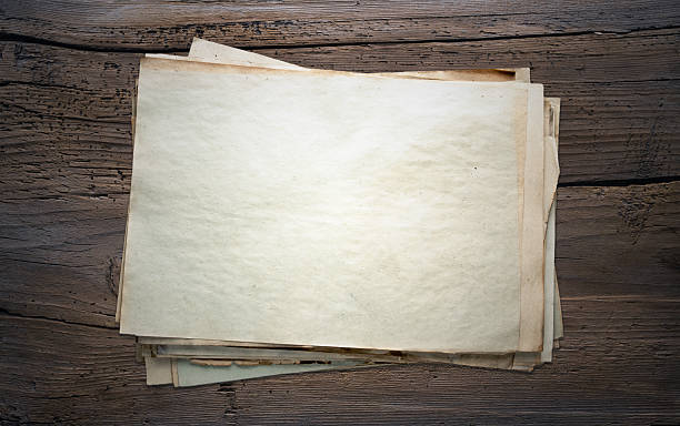 istock old papers on wooden background 467336663