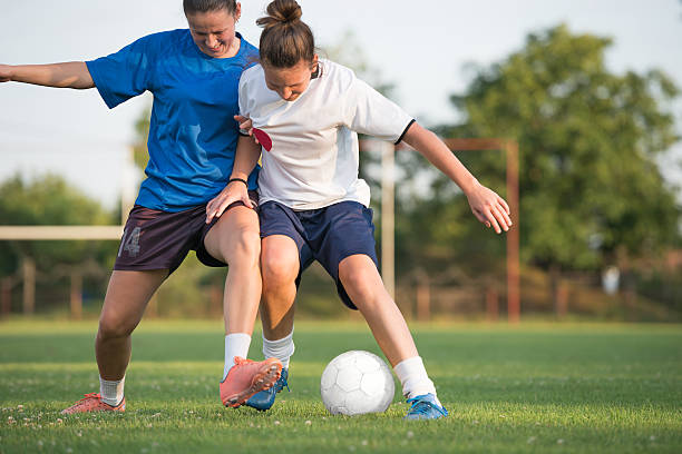 female soccer two female soccer players on the field soccer soccer ball kicking adult stock pictures, royalty-free photos & images