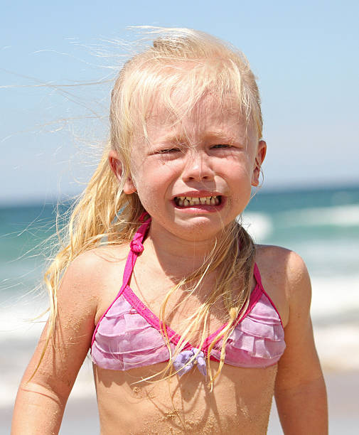 Beautiful blond woman is lying happily on the sandy beach