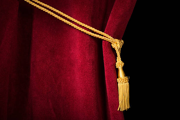 istock A red velvet curtain pulled back by a gold tassel 467340185