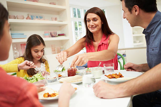 istock Hispanic family sitting at the table for dinner 467340347