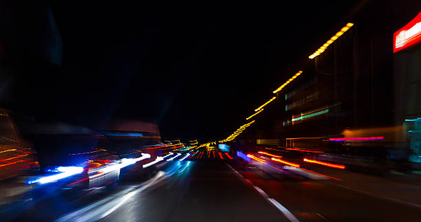 istock car lights on highway by night,abstract light trace background 467342198