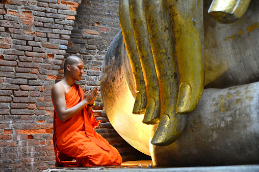 Monk chanting Buddha in wat sri chum,sukhothai Thailand
