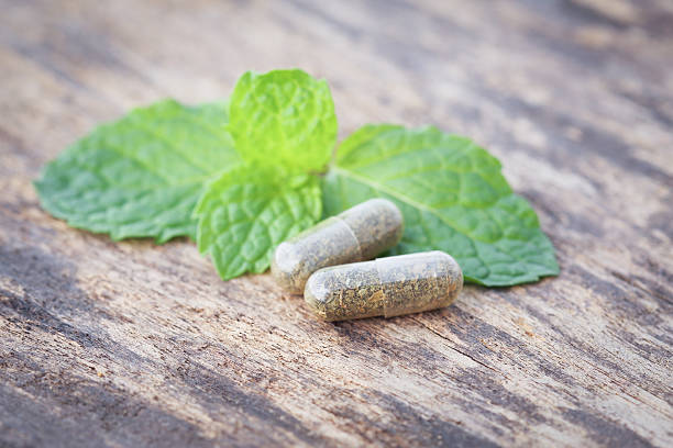 istock herbal medicine pills with mint leaf 467342944