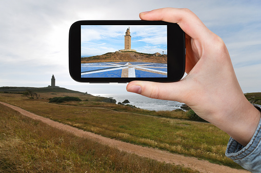 tourist taking photo of lighthouse Tower of Hercules