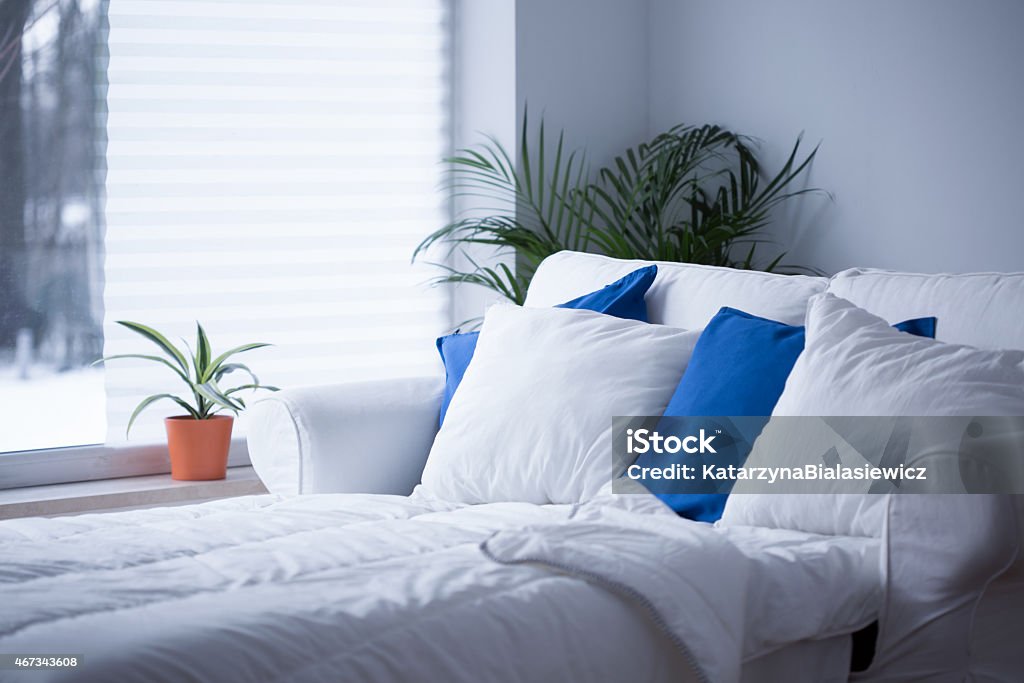 White and blue cushions White and blue cushions on the bed Duvet Stock Photo