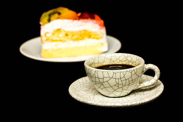 istock cup of coffee and fruit cake on black background 467344215