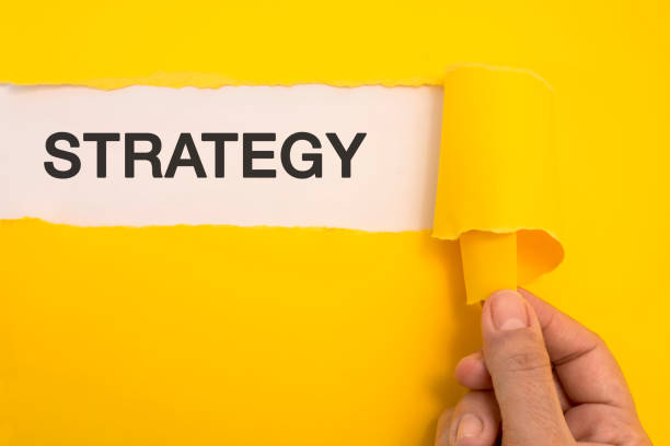 istock Female hand tearing the word Strategy 467346206