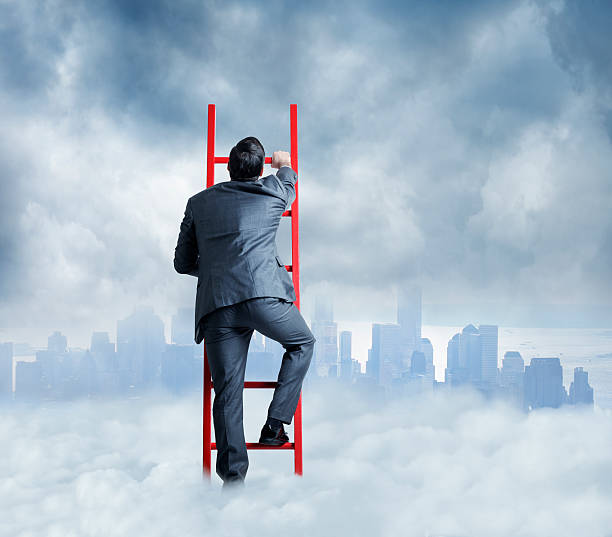 Businessman Climbing A Ladder For A Better Look