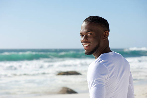 istock Happy smiling african american man at the beach 467346310