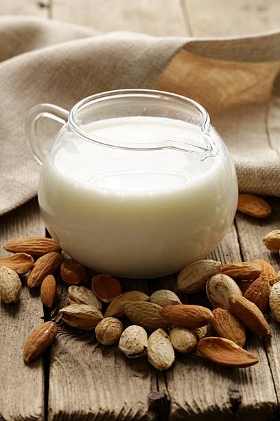 istock almond milk in a glass jug with whole nuts 467347041