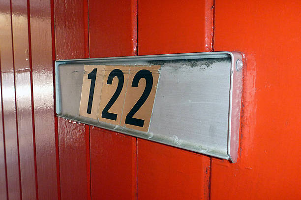 Number 126 letterbox on a red door