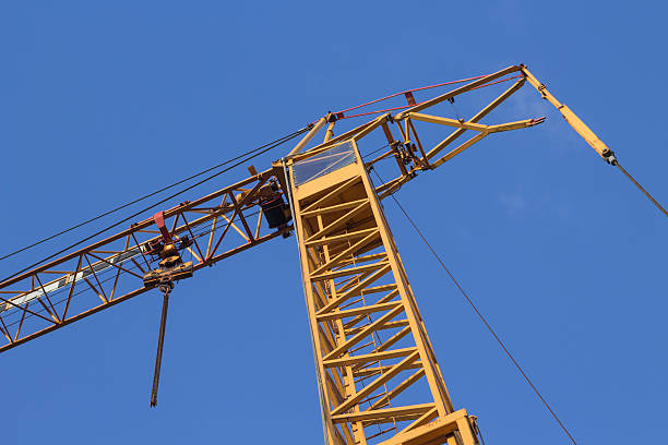 istock yellow construction crane in front of a blue sky 467357027