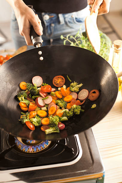 istock Chef cooking vegetables in wok pan 467359008