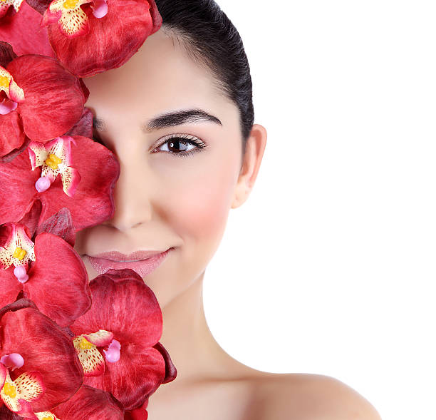 istock Woman with orchid flowers on face 467361936