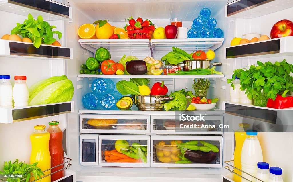 Full open fridge with lots of vegetables Open fridge full of fresh fruits and vegetables, healthy food background, organic nutrition, health care, dieting concept Refrigerator Stock Photo