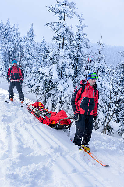 istock Ski patrol transporting injured skier snow forest 467364747