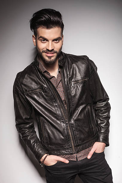 istock fashion man posing against white wall 467366612