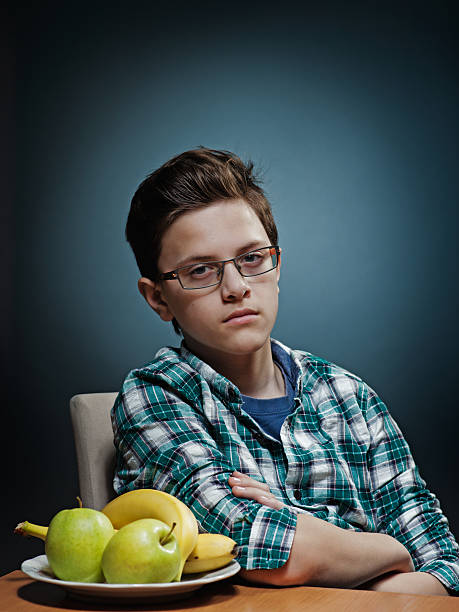 Teenager hating fruits two stock photo