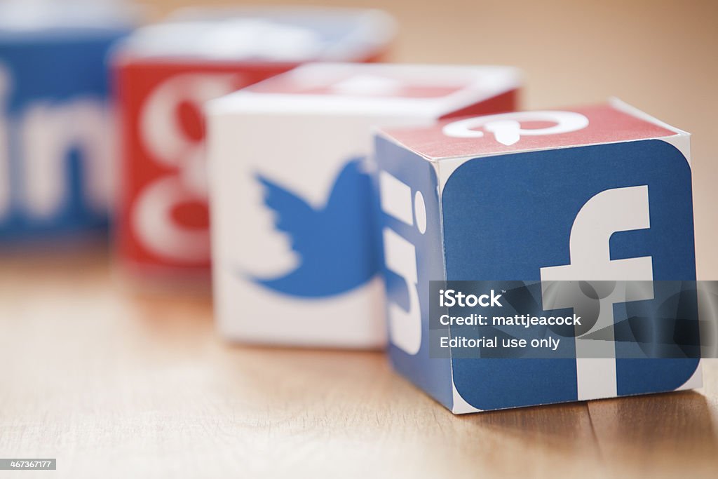 Social media cubes on a wooden background London, United KIngdom- February 3, 2014: Social media logos printed onto handmade cubes. Logos include Facebook, linkedin, twitter. Social media uses web and mobile technology to connect people Social Media Stock Photo